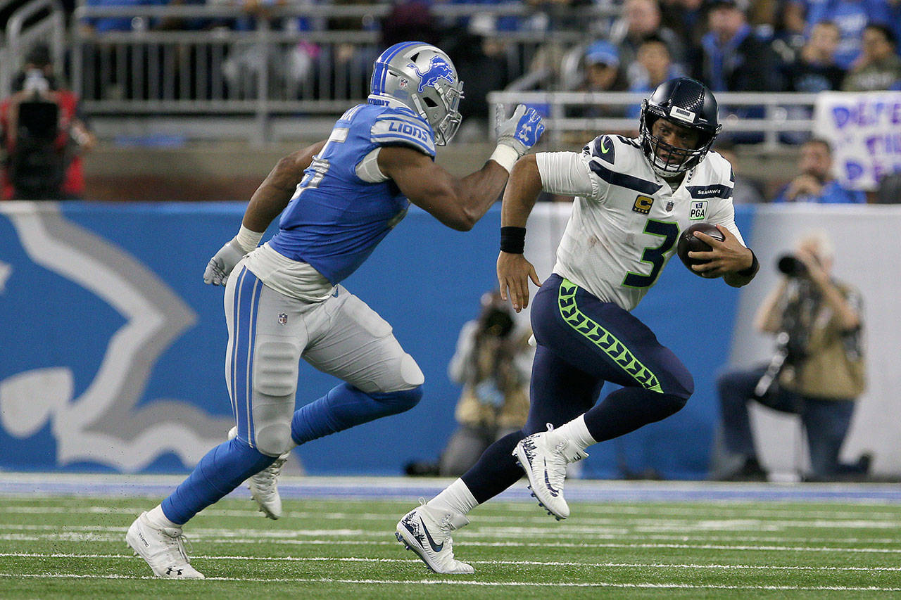 Seattle Seahawks quarterback Russell Wilson (3) runs the ball under the pressure of Detroit Lions defensive end Romeo Okwara (95) during the second half of an NFL football game against the Detroit Lions in Detroit, Michigan USA, on Sunday, October 28, 2018. (Photo by Amy Lemus/NurPhoto/Sipa USA)