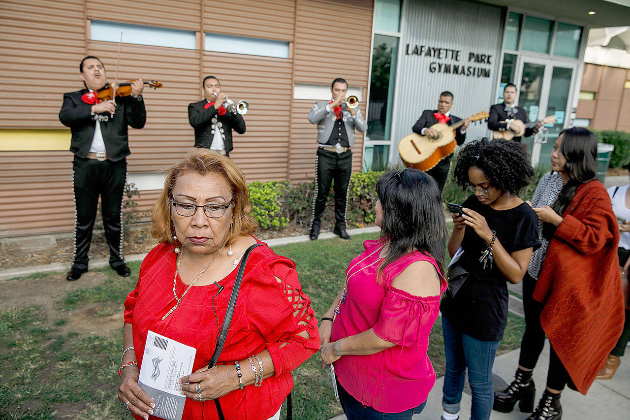 Griselda Sanchez, left, waits in line at the polls to vote as she and other voters are serenaded by the Mariachi Cuicatlan in Los Angeles on Tuesday. Turnout was expected to be strong across the nation. Due to press deadlines, election results can be found online now at thedailyworld.com and in Wednesday’s edition of The Daily World. (Marcus Yam / Los Angeles Times)
