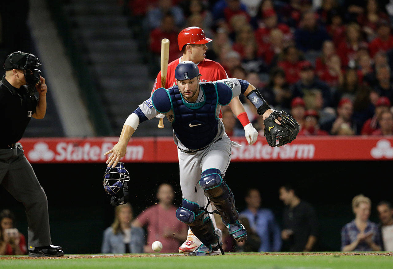 Seattle Mariners catcher Mike Zunino runs after a passed ball with the Los Angeles Angels’ C.J. Cron at the plate on Friday, April 7, 2017. Zunino was traded to the Tampa Bay Rays on Thursday. (Gina Ferazzi/Los Angeles Times/TNS)