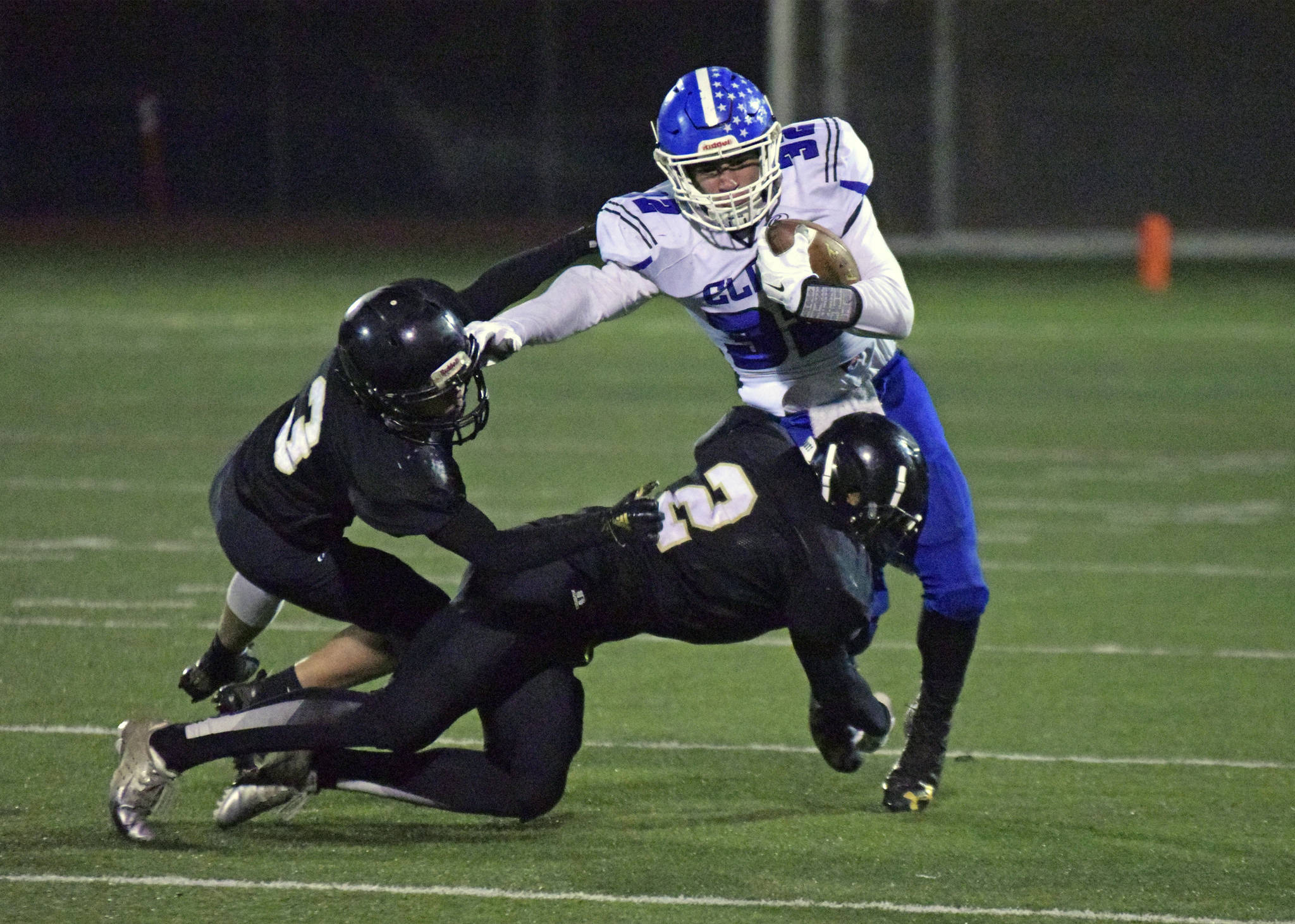Elma’s Taitum Brumfield is tackled by Meridian’s Cameron Webster (2) during Saturday’s first-round state playoff game in Bellingham. (Eric Trent | Lynden Tribune)
