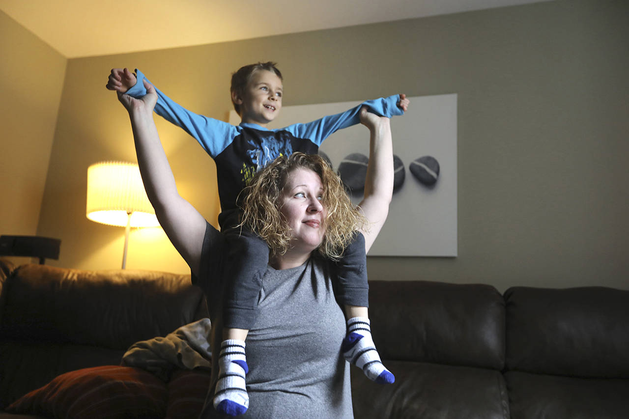 David Swanson | Philadelphia Inquirer                                 Nichole Lowther plays with her son in their living room. She wasn’t diagnosed with autism until Matthew, now 6, was diagnosed a few years ago.
