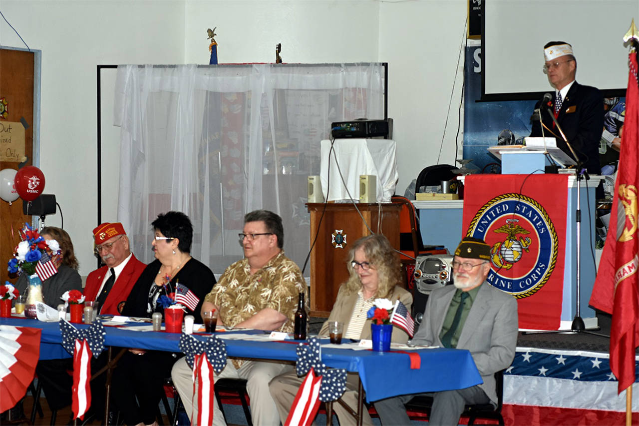(Courtesy photo) Emcee Jim Daly speaks during the event. Seated at the head table, from right, are Anthony Magri, commander of VFW Post 224, and his wife Jan; Steve Leeson, the guest of honor, with his wife Rhonda; and Frank Perov, commandant of MCL Det. 442, and his wife Jerri.