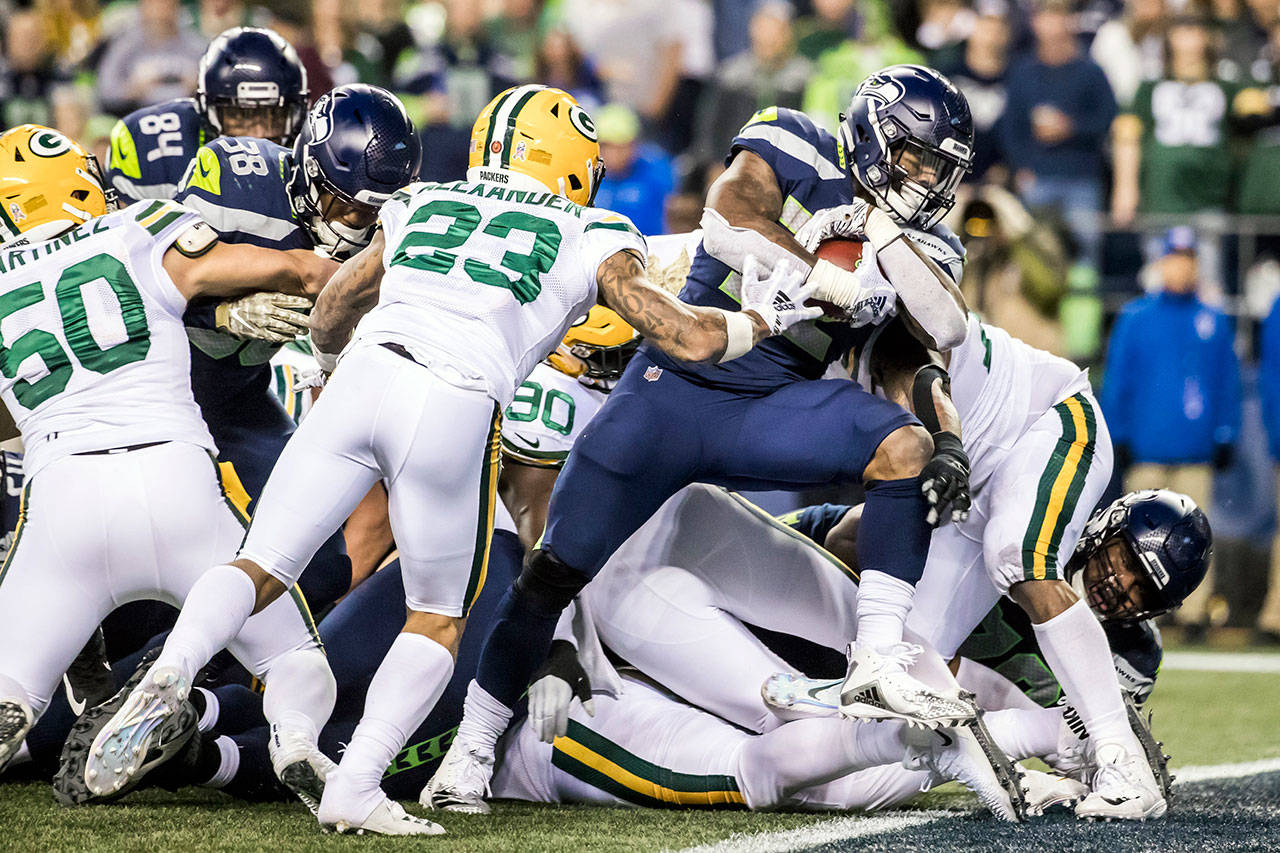 Seattle Seahawks running back Chris Carson takes the ball across the line for a 1-yard touchdown in the second quarter against the Green Bay Packers at CenturyLink Field in Seattle on Thursday, Nov. 15, 2018. (Bettina Hansen/Seattle Times/TNS)