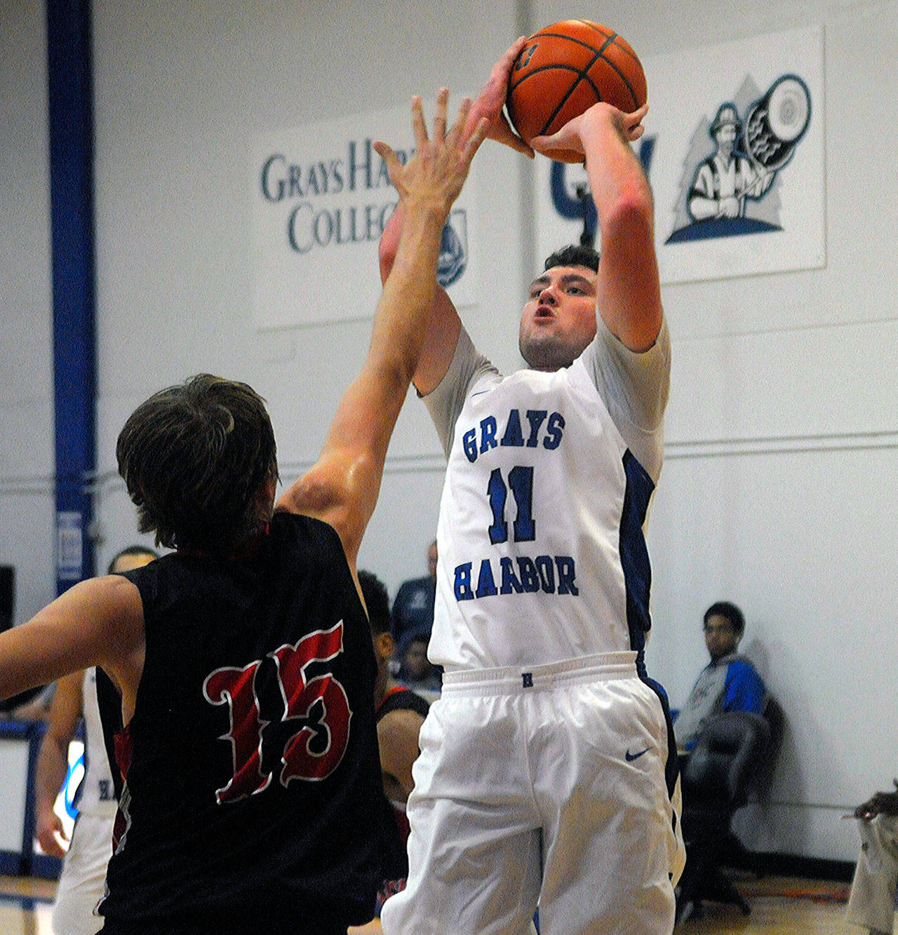 Grays Harbor’s Dallin Spencer hits a post fade-away over Caleb Sheldon in a game against Skagit on Friday. Spencer led the team with 10 rebounds. (Hasani Grayson | Grays Harbor News Group)