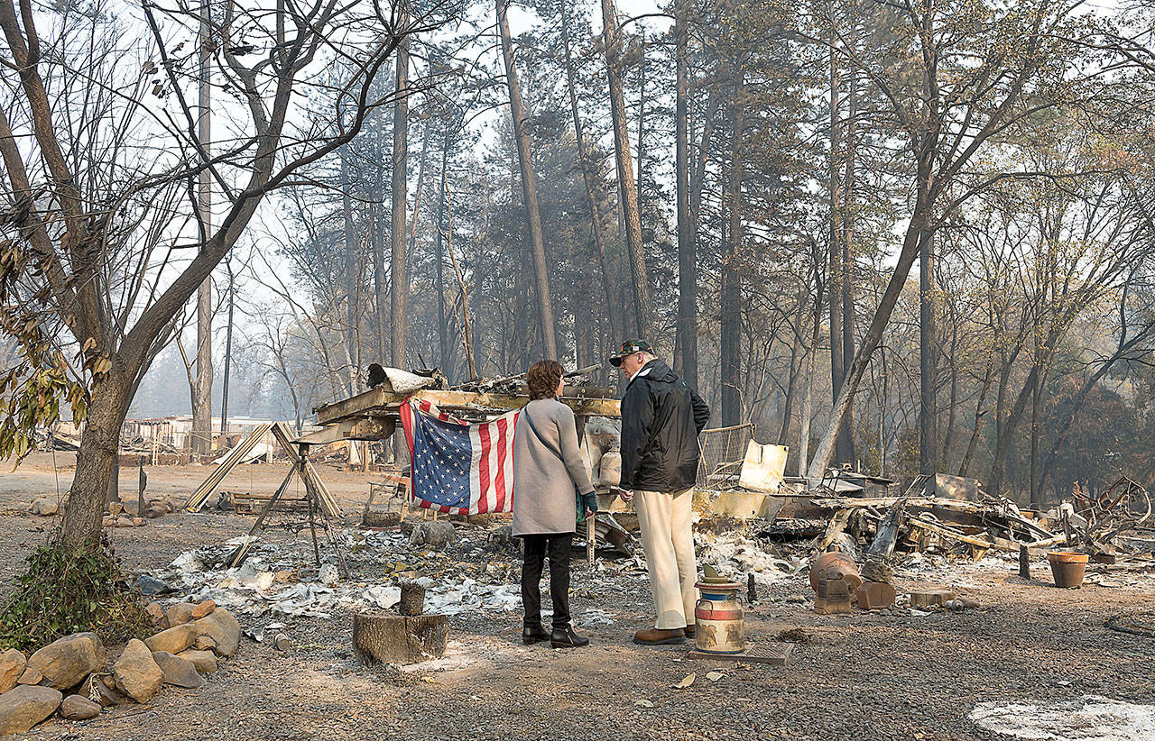 President Donald Trump surveys the damage with Paradise Mayor Jody Jones as they tour the Skyway Villa Mobile Home and RV Park during his visit of the Camp Fire in Paradise, Calif. on Saturday, 2018. The Camp Fire in Northern California has become the nation’s deadliest wildfire in a century and has killed at least 63 people and left about 1,000 still missing. (Paul Kitagaki Jr./The Sacramento Bee)