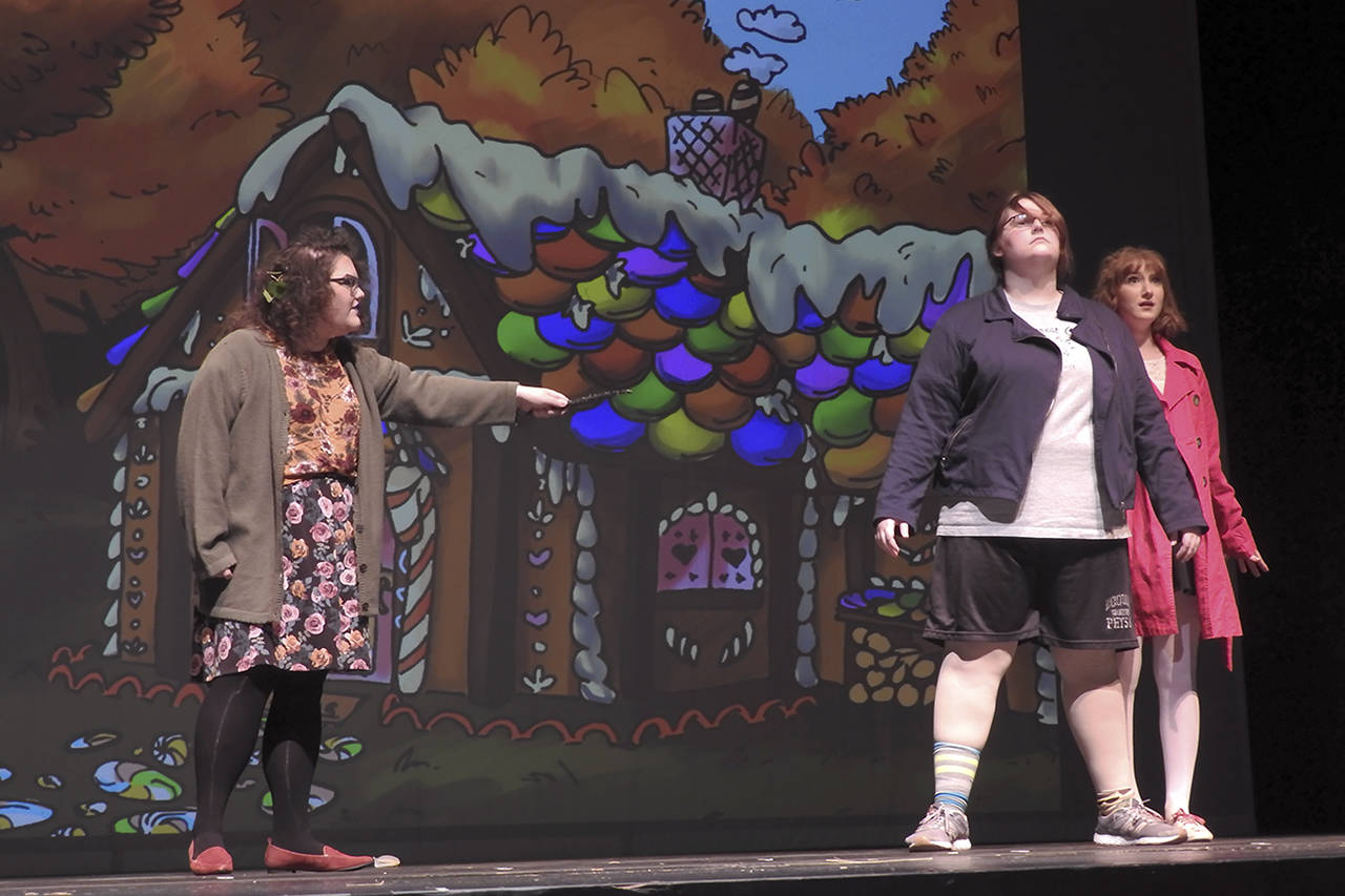 (Kat Bryant | Grays Harbor News Group) The Gingerbread Witch (played by GHC student Marlena Luzzi) casts a spell on Hansel and Gretel (GHC student McKenna Hansen, left, and Aberdeen High School student Emma Dorsch).