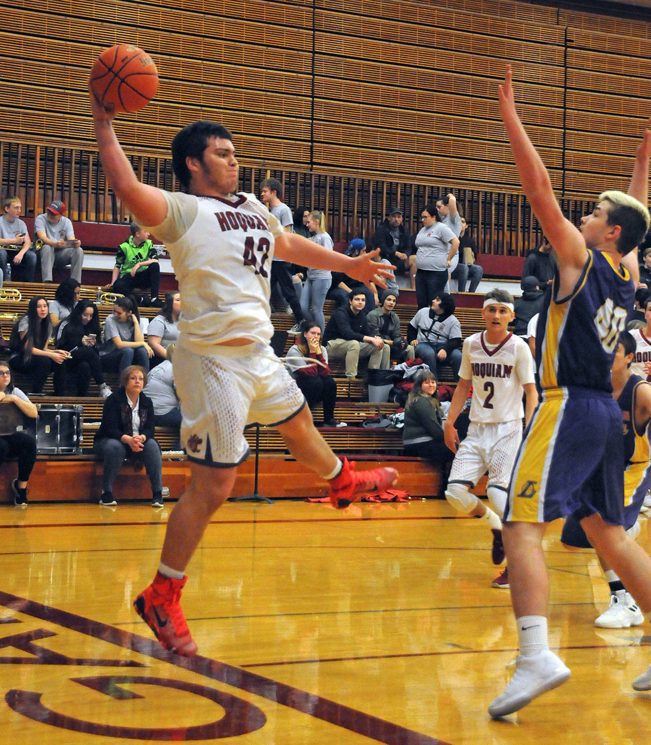 Hoquiam’s Matt Brown, left, attempts to prevent a turnover during the Grizzlies 68-59 season-opening victory over Onalaska on Wednesday in Hoquiam. (Ryan Sparks | Grays Harbor News Group)