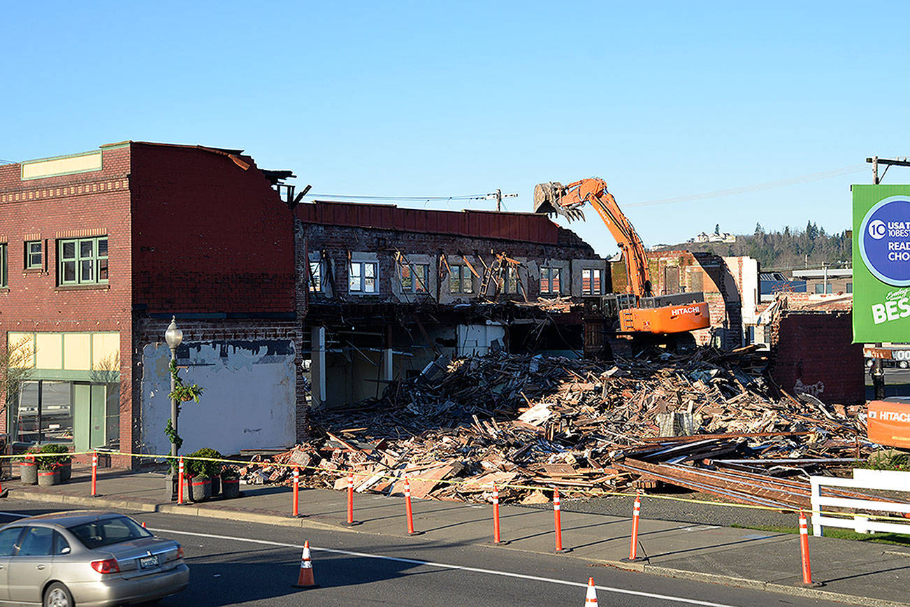 (Louis Krauss | Grays Harbor News Group)                                An excavator from Rognlins Inc. demolishes the old Selmers Furniture building in Aberdeen next to the Pourhouse, which was also taken down.