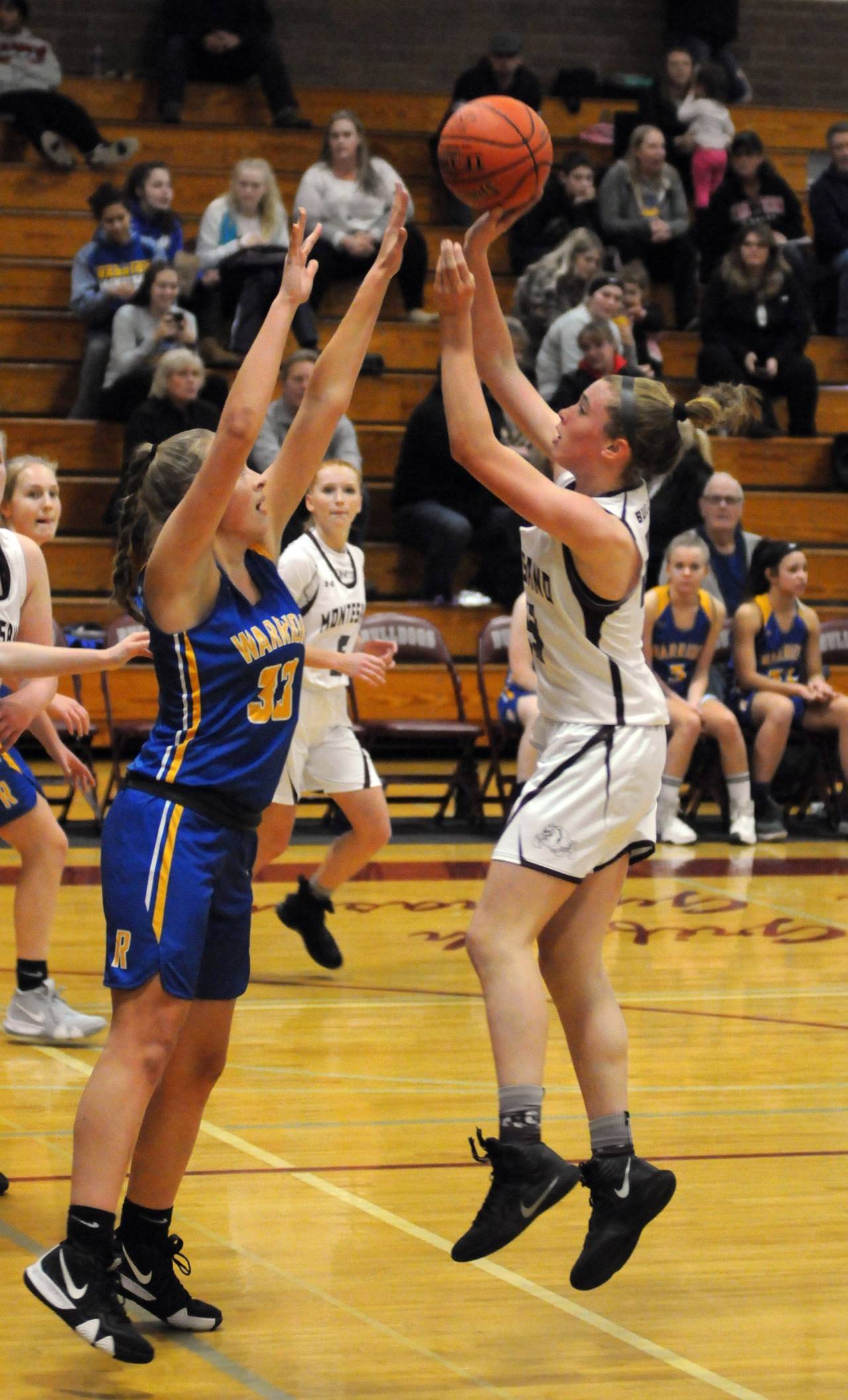 Monte’s Paige Lisherness, right, puts up a jump shot over Rochester’s Emily Elkins in the Bulldogs’ overtime loss on Tuesday in Montesano. (Ryan Sparks | Grays Harbor News Group)