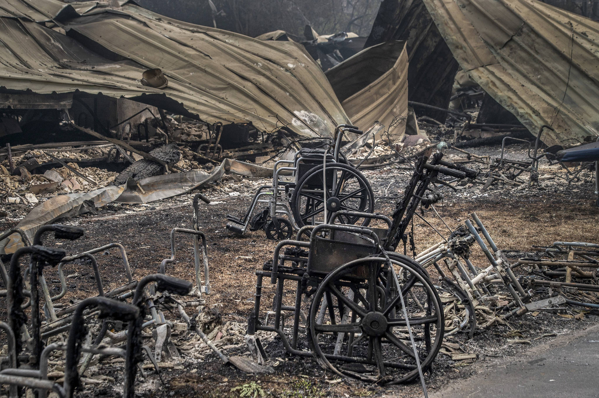 (Renee C. Byer/The Sacramento Bee/TNS) Burned wheelchairs are all that remain from a senior care facility from the Camp Fire Thursday Nov. 15, 2018 in Paradise, Calif.