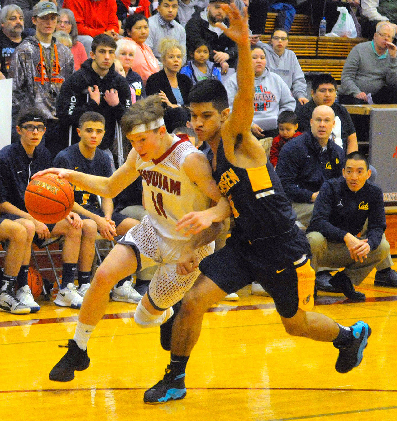 Hoquiams Cameron Bumstead, left, drives toward the paint while defended by Aberdeens Javier Bojorge in the first quarter on Friday. (Hasani Grayson | Grays Harbor News Group)