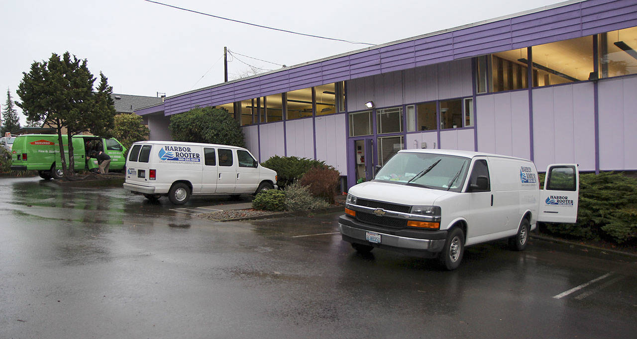 Harbor Rooter and ServPro vans sit Wednesday outside the W.H. Abel Library in Montesano after flooding forced closure of the building. The branch is closed until further notice.