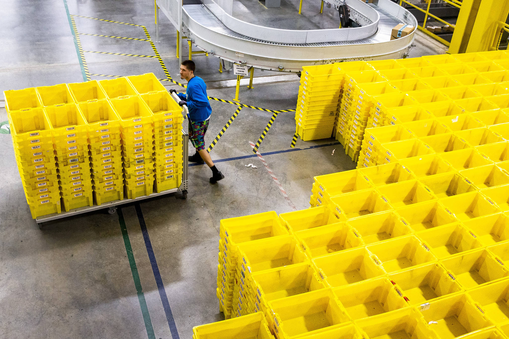 An employee organizes crates at an Amazon fulfillment center in Grapevine, Texas, on December 5, 2018. (Shaban Athuman/Dallas Morning News/TNS)