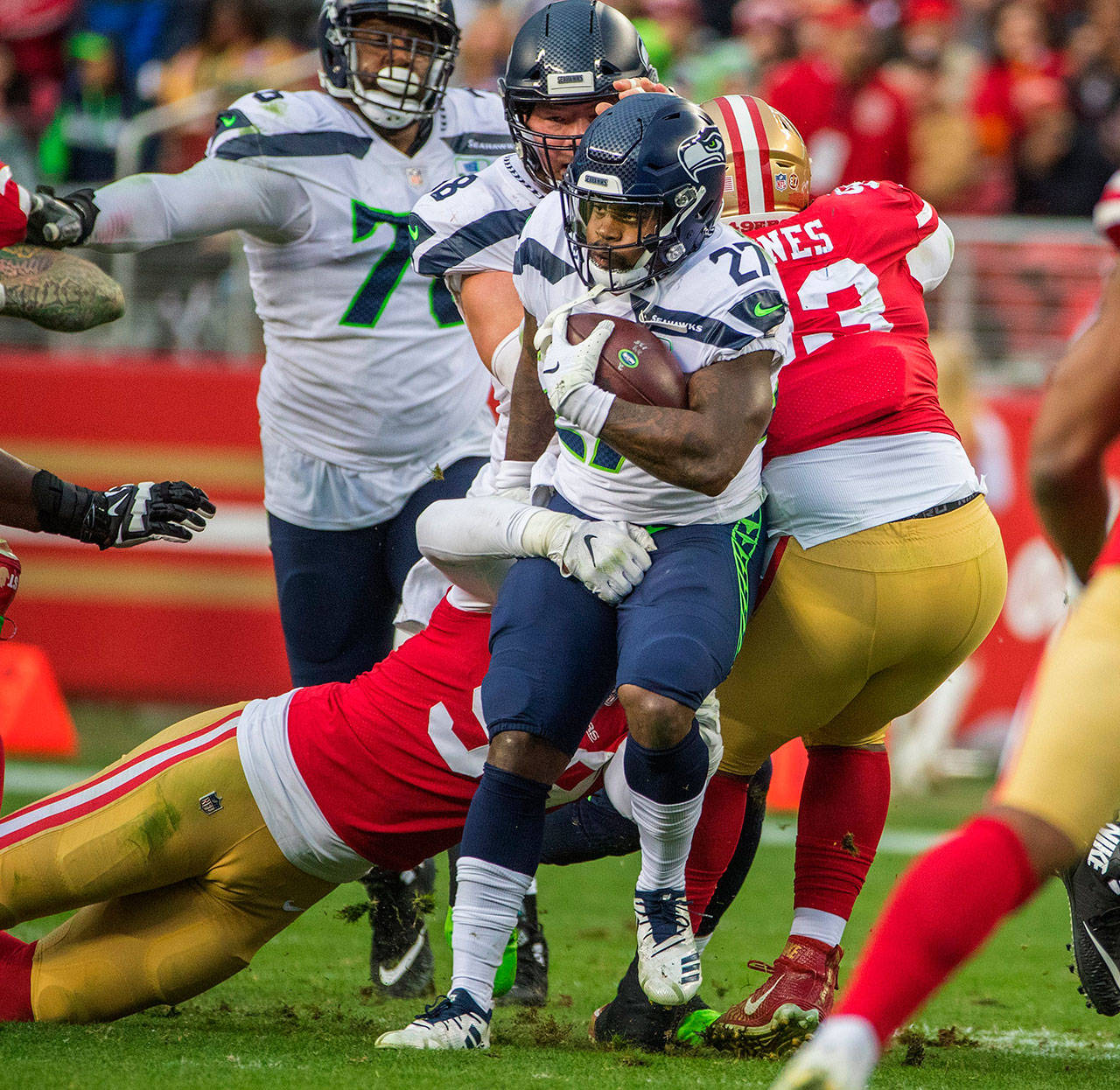 Seattle Seahawks running back Mike Davis (27) runs through a crowd of San Francisco 49ers defenders during second quarter action on Sunday, Dec. 16, 2018 at Levi’s Stadium in Santa Clara, Calif. (Mike Siegel/Seattle Times/TNS)