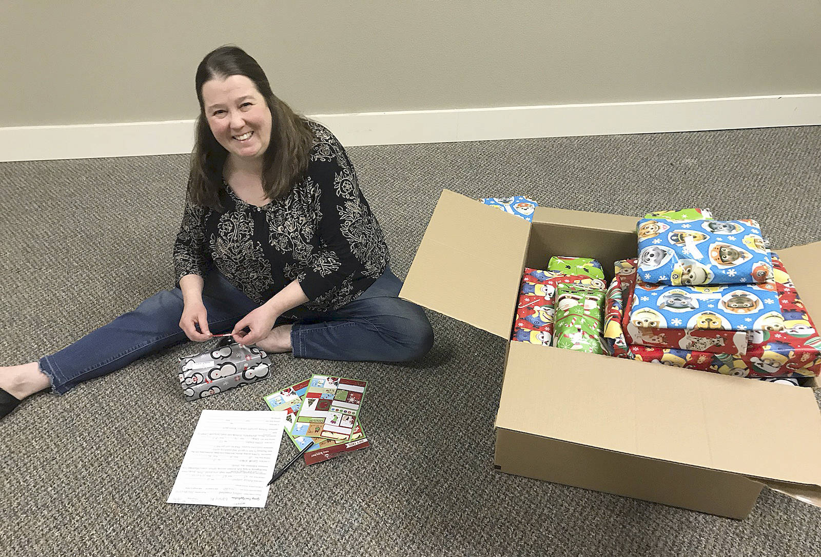 Courtesy Kyna Wilson                                Dawn Toney, a licensed mental health counselor at Olympia Therapy, prepares gifts for a drive led by Hands-On-Health Chiropractic.