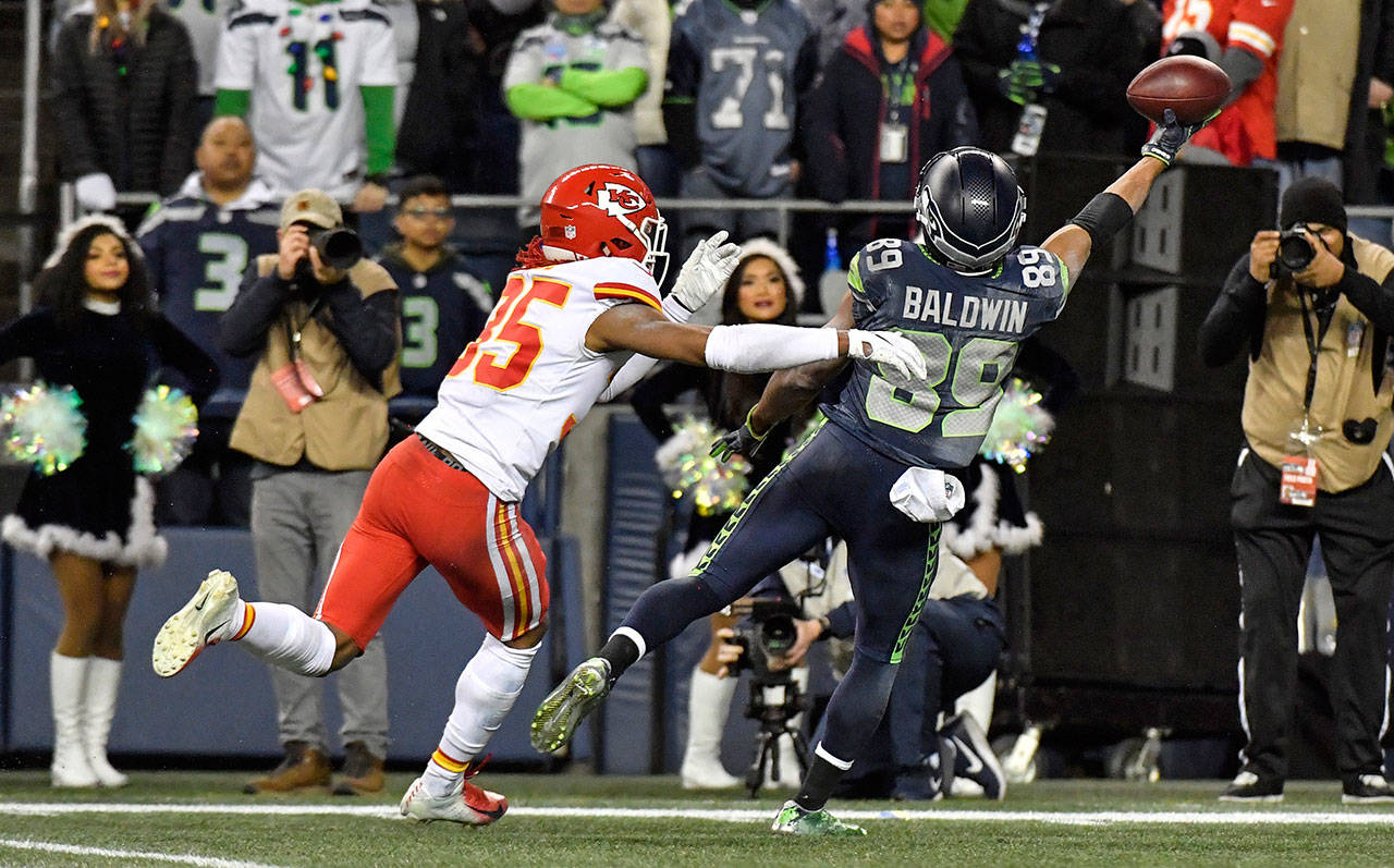 Seattle Seahawks wide receiver Doug Baldwin pulls in a one-handed catch past the defense of Kansas City Chiefs cornerback Charvarius Ward late in the fourth quarter to put the Seahawks close to the goal line during Sunday’s football game on Dec. 23, 2018 at CenturyLink Field in Seattle, Wash. The Seahawks won, 38-31. (John Sleezer/Kansas City Star/TNS)