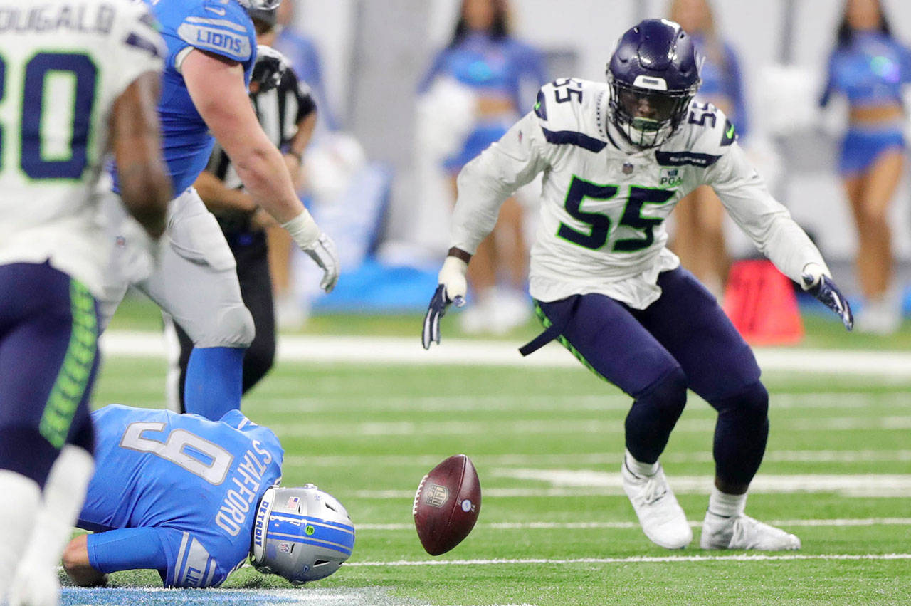 Detroit Lions quarterback Matthew Stafford fumbles the ball trying to scramble as Seattle Seahawks defensive end Frank Clark tries to recover the ball during fourth quarter action on Sunday, Oct. 28, 2018 at Ford Field in Detroit, Mich. (Kirthmon F. Dozier/Detroit Free Press/TNS)
