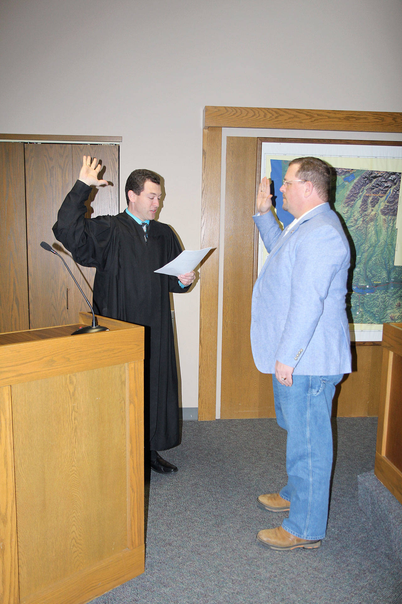 Michael Lang | Grays Harbor News Group                                Grays Harbor County Auditor Joe MacLean (right) is sworn in to office Jan. 2 by Judge David Mistachkin in County Commission chambers in Montesano.