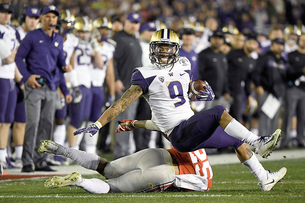 Myles Gaskin (9) of the Washington Huskies is stopped by Brendon White (25) of the Ohio State Buckeyes during the second half in the Rose Bowl Game presented by Northwestern Mutual at the Rose Bowl on Tuesday in Pasadena, Calif. (Kevork Djansezian/Getty Images/TNS)