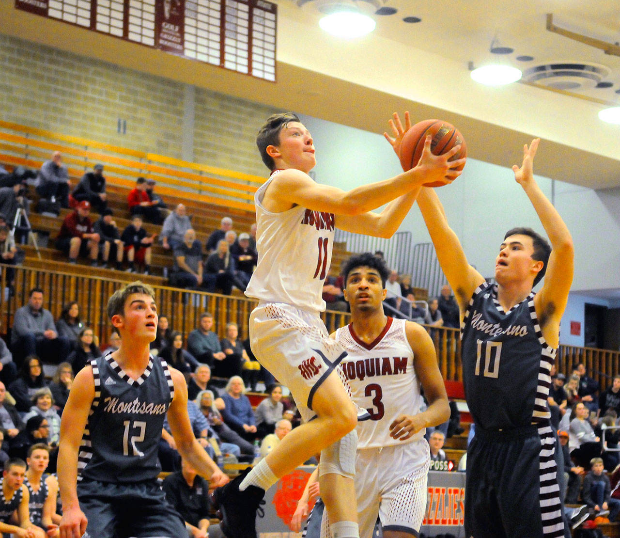 Hoquiam’s Cameron Bumstead finishes a reverse layup in the second quarter against Montesano on Wednesday. Bumstead scored 16 points and had four assists in Hoquiam’s 57-56 win. (Hasani Grayson | Grays Harbor News Group)