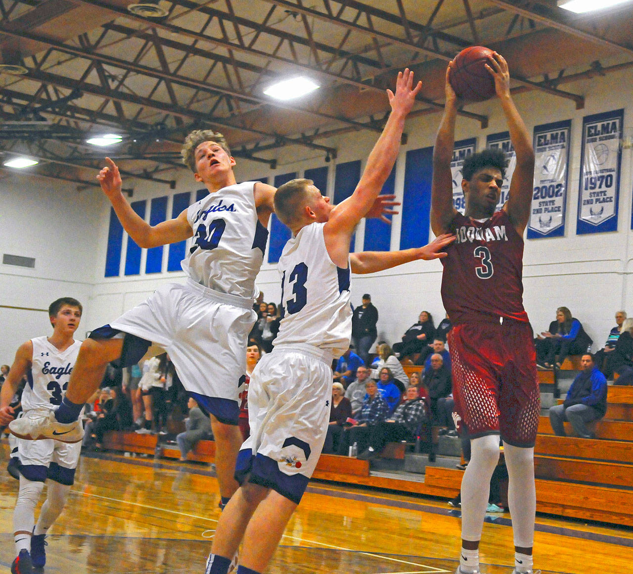 Hoquiam’s Rayyon Dayton (3) snatches a rebound from Cody Vollan (13) and Josiah Jones-Wyeth on Friday. Dayton led the Grizzlies with 16 points and 16 rebounds (Hasani Grayson | Grays Harbor Newsgroup)