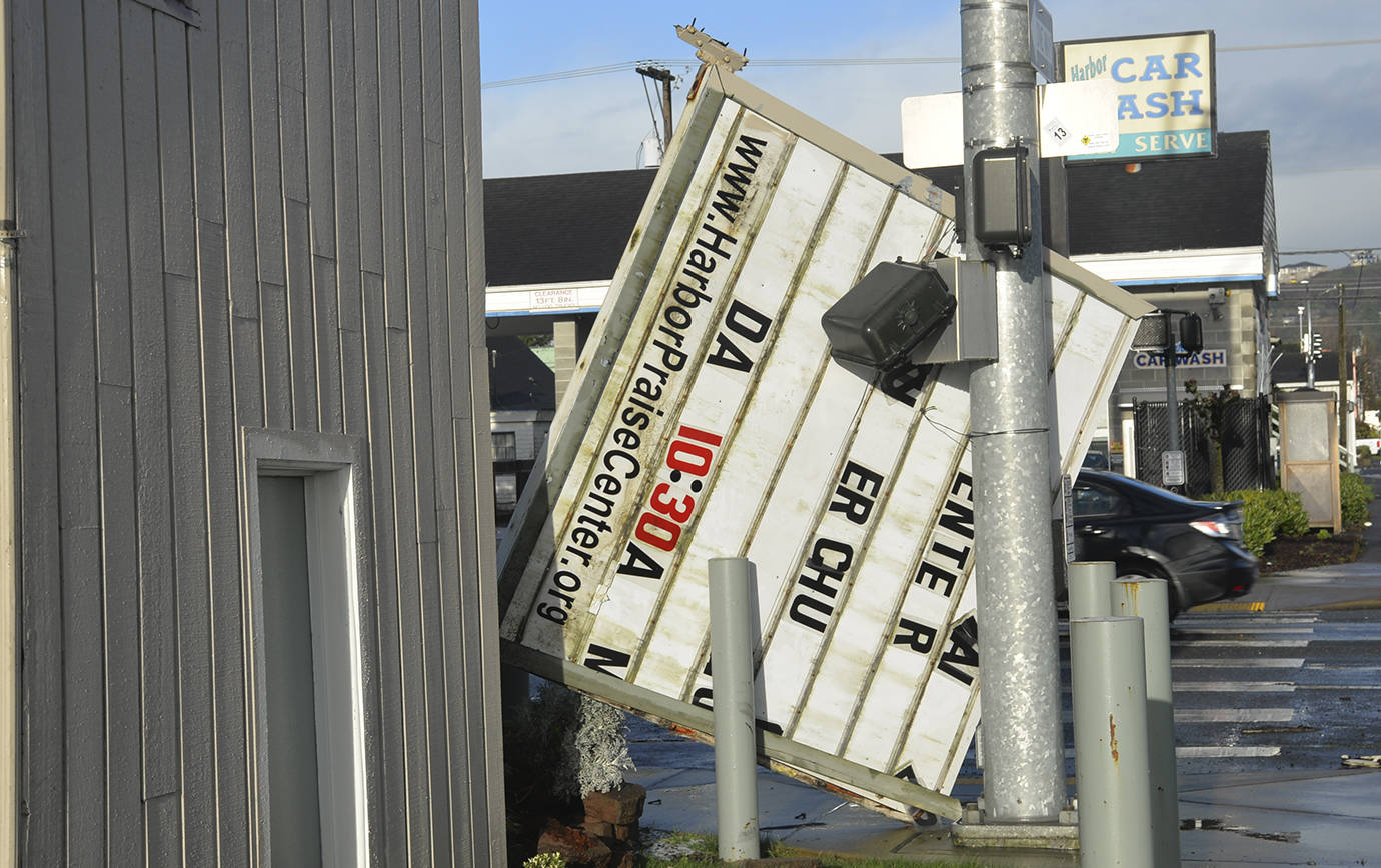 DAN HAMMOCK | GRAYS HARBOR NEWS GROUP                                Strong winds knocked the sign off the Harbor Praise Center at the corner of West Wishkah and South Park streets in Aberdeen Sunday morning. Monday morning the traffic light at the intersection was still blinking and the crosswalk signals were disabled.