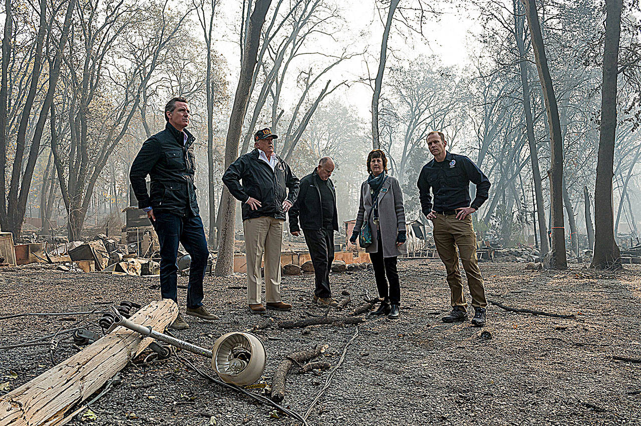 Gov.-elect Gavin Newson, FEMA Director Brock Long, President Donald Trump, Paradise mayor Jody Jones and Gov. Jerry Brown tour the Skyway Villa Mobile Home and RV Park with Gov. Jerry Brown during his visit of the Camp Fire in Paradise, Calif., on Saturday, Nov. 17, 2018. (Paul Kitagaki Jr./The Sacramento Bee)