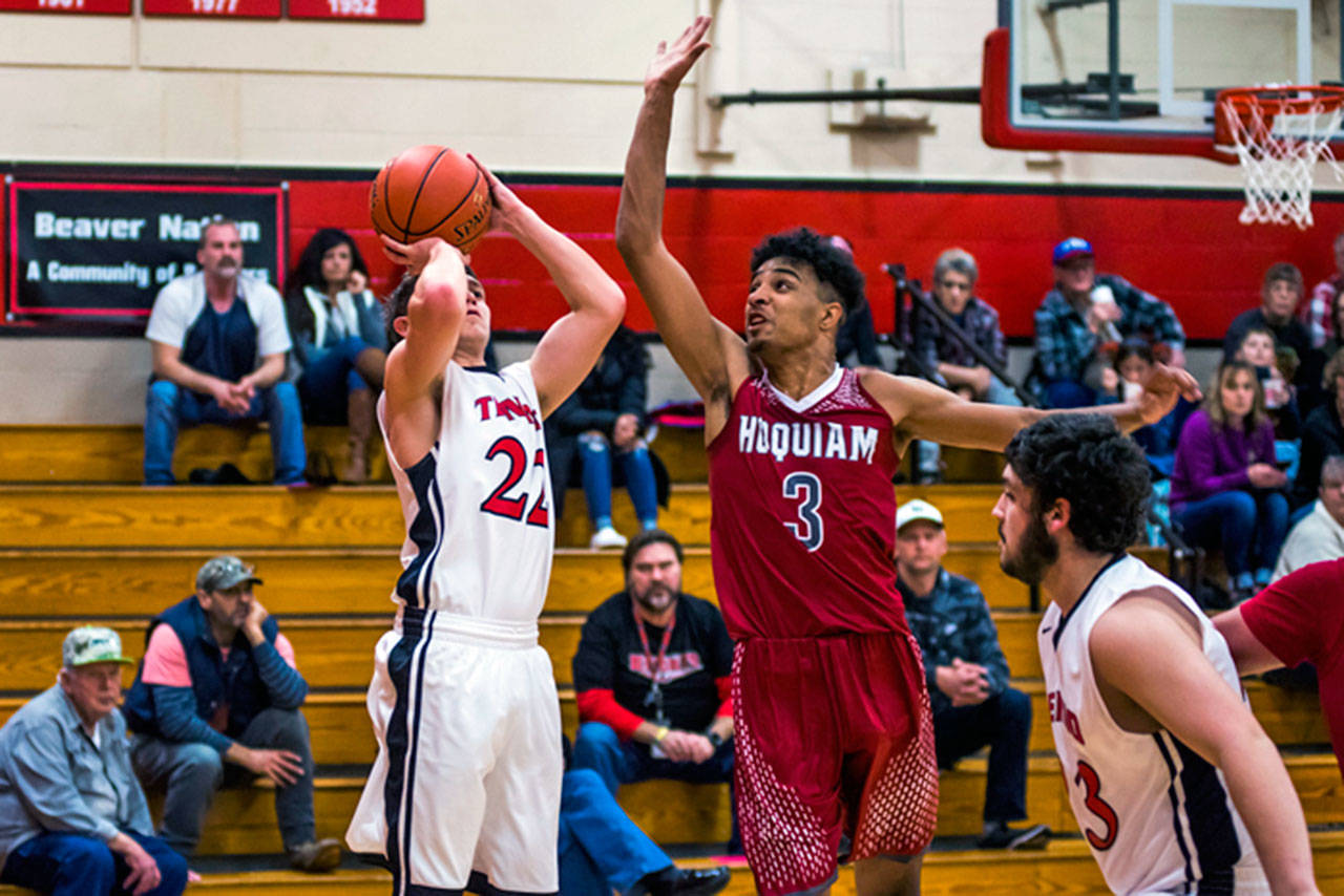 Hoquiam’s Rayyon Dyaton, right, comes over to contest a shot from Tenino’s Logan Brewer on Friday night. (Jared Wenzelburger | Centralia Chronicle)