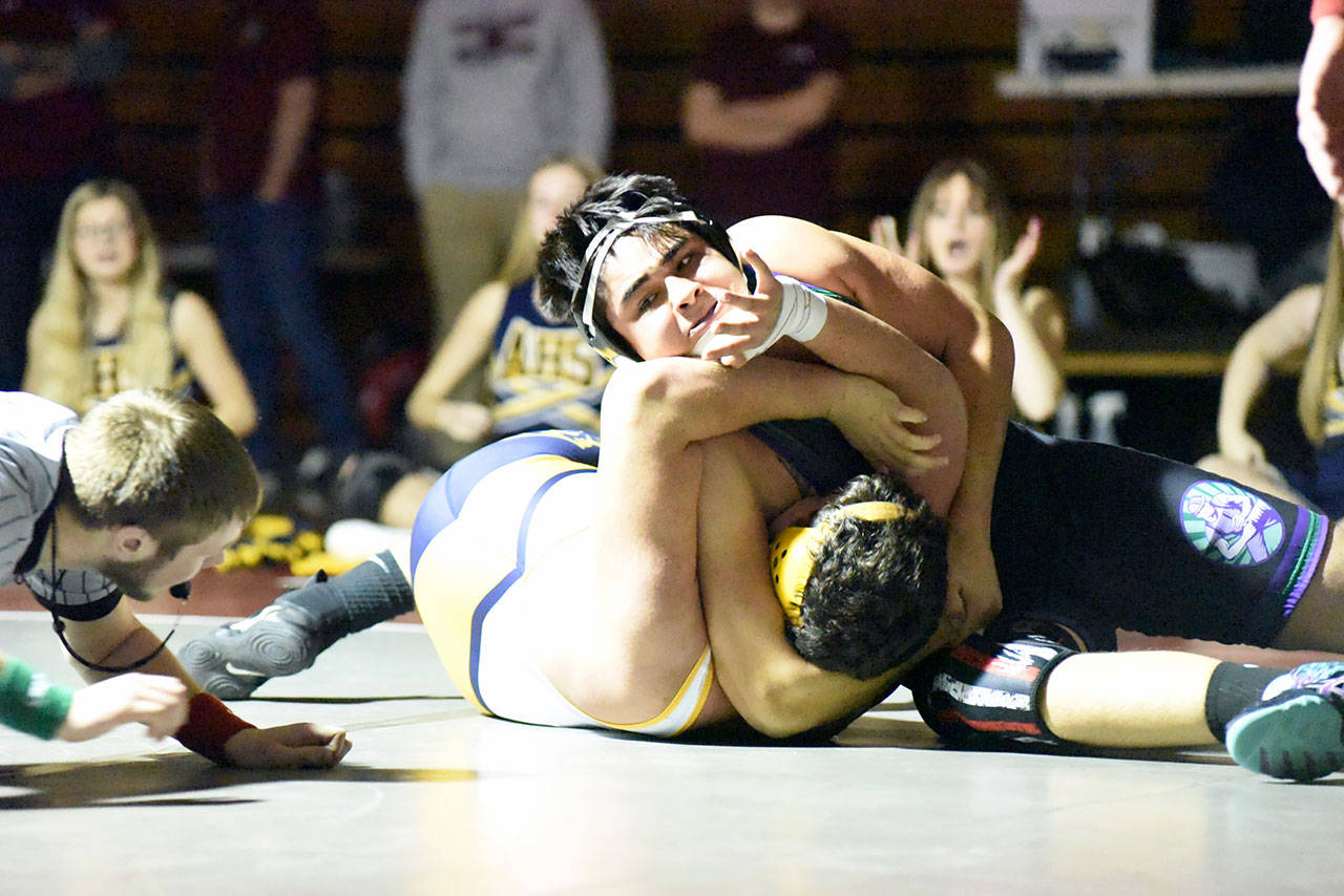 Willapa Harbor’s Christian Anderson, top, works to pin Aberdeen’s Enrique Ontiveros during the heavyweight final of the Grizzly Alumni Invitational on Saturday in Hoquiam. (Photo by Sue Michalak)