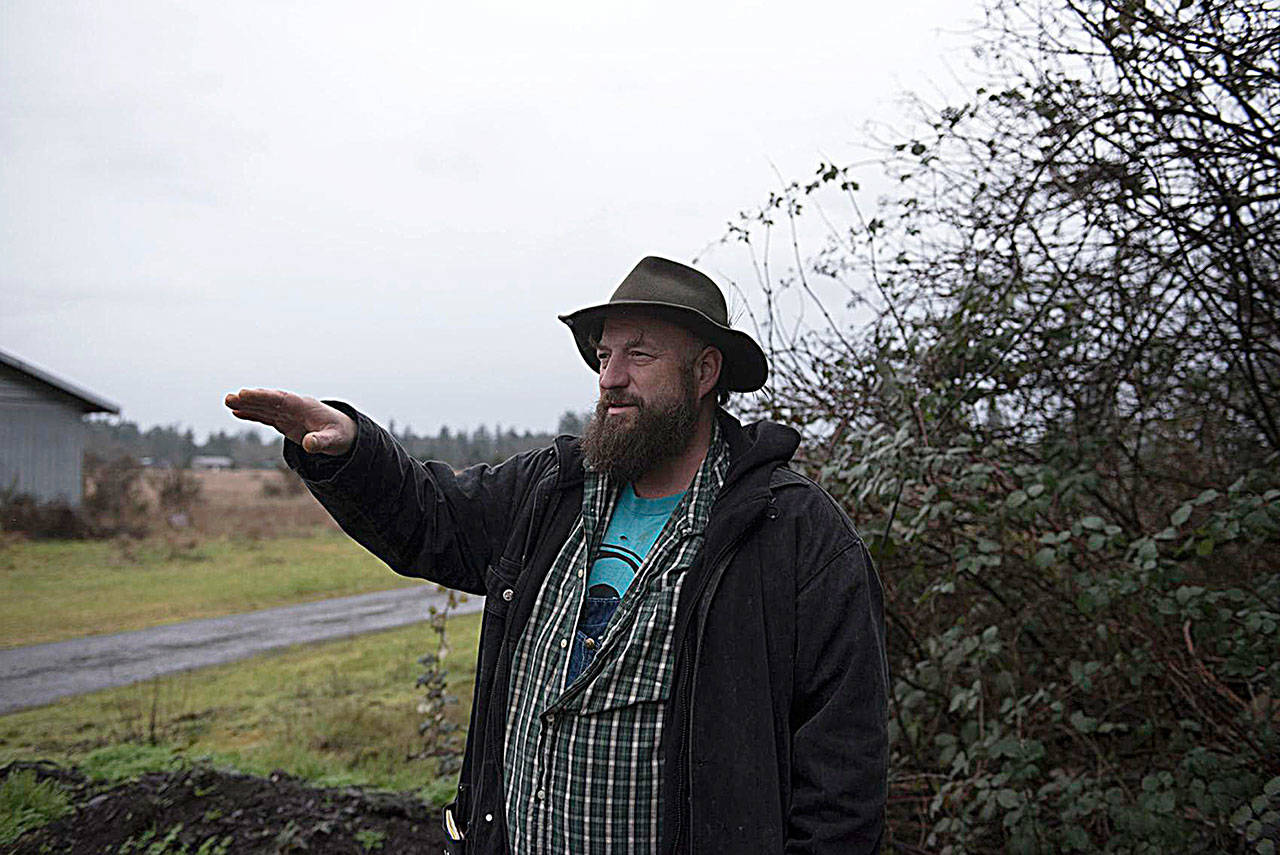 Deston Denniston, executive director of VETS_CAFE, stands on a donated 120-acre plot of land on Wednesday, Jan. 9, and discusses the layout of the land. (Cody Neuenschwander | The Chronicle)