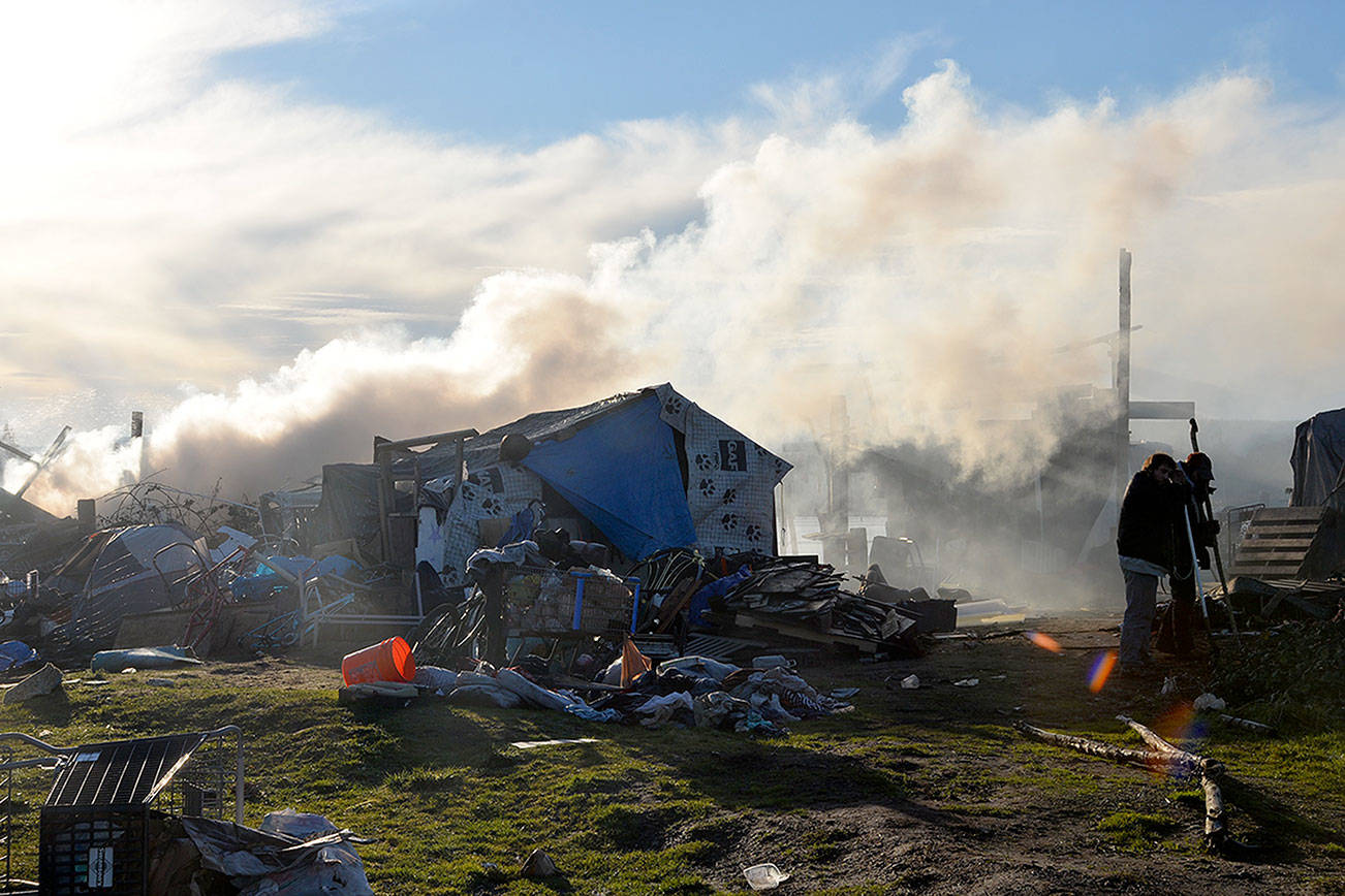 Louis Krauss | Grays Harbor News Group                                A wooden shack burned down at the River City homeless camp along the Chehalis River on Tuesday morning.