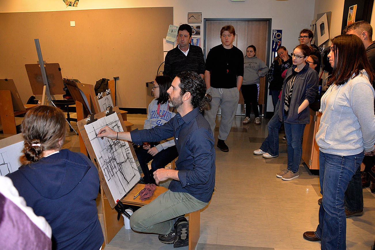 Louis Krauss | Grays Harbor News Group                                Art instructor Nathan Barnes demonstrates how to incorporate the room’s dimensions during a drawing class at Grays Harbor College.