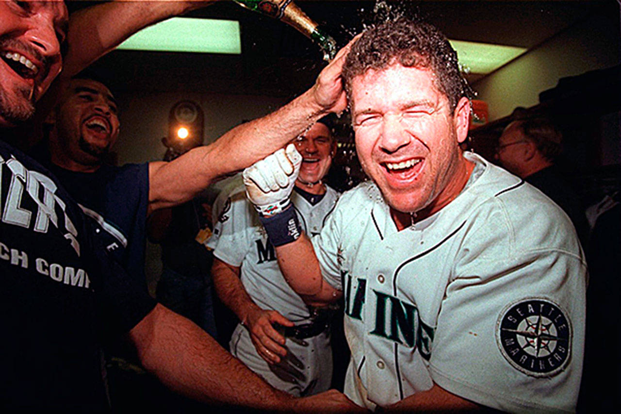 Edgar Martinez is covered with champagne in the Mariner locker room following his base hit which scored two runs in the bottom of the 11th inning in Game 5 of the 1995 American League Division Series. Martinez received his call to the Hall of Fame on Tuesday in his last year of eligibility. (Seattle Times file photo)