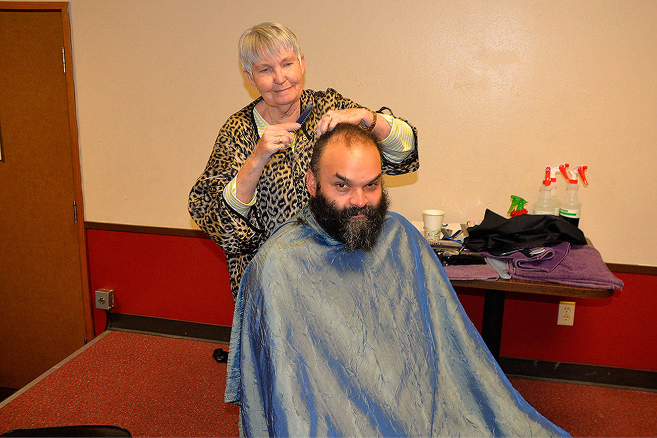 Louis Krauss | Grays Harbor News Group                                Pat Gordon cuts Jeffrey Traversie’s hair at the Project Homeless Connect event Friday in the Aberdeen Senior Center, which is now housed in the former Aberdeen Eagles Building.