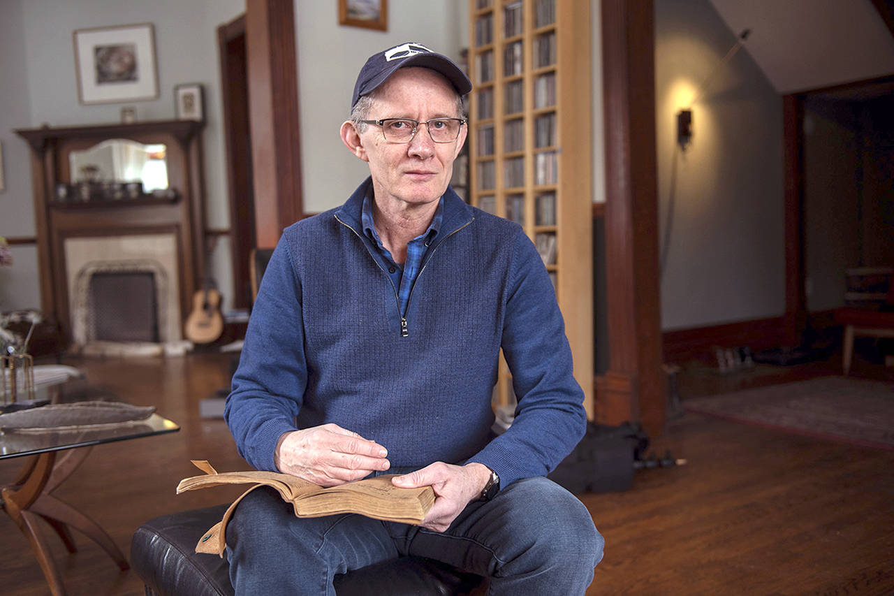 Rob Hart | Chicago Tribune                                 Bruce Sheridan with his journals in his home. The musician and filmmaker has kept journals regularly since childhood.