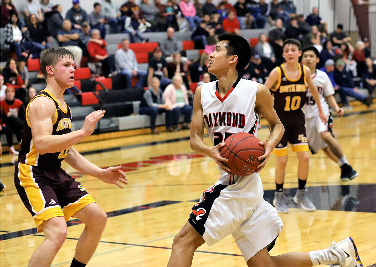 Raymond’s Devine Souvannavahn, right, drives against South Bend’s Drew Rose during Raymond’s 60-58 victory on Thursday (Photo by Larry Bale)
