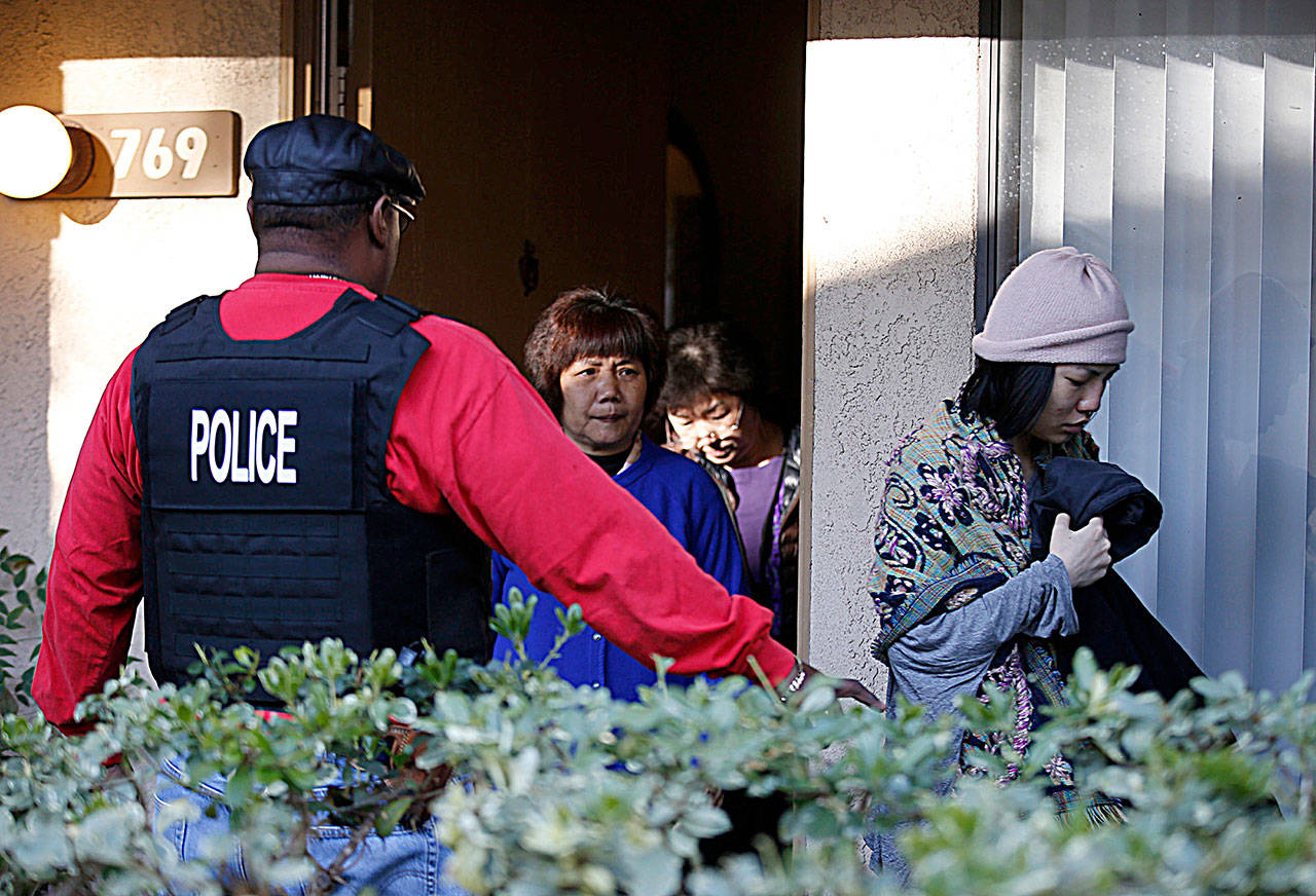 Federal agents serve warrants and question several residents at an apartment complex in Rowland Heights, Calif., while investigating alleged birth tourism centers in 2015. (Mark Boster/Los Angeles Times)