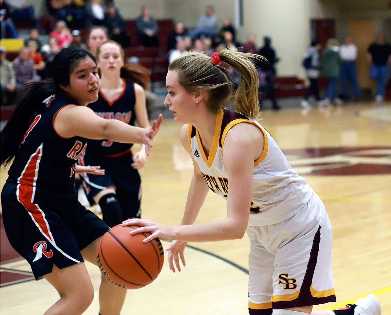 South Bend’s Karley Reidinger, right, drives to the hoop in a win over Raymond on Wednesday. South Bend earned a No. 4 seed and a first-round bye in this week’s 2B District IV Tournament. (Photo by Larry Bale)