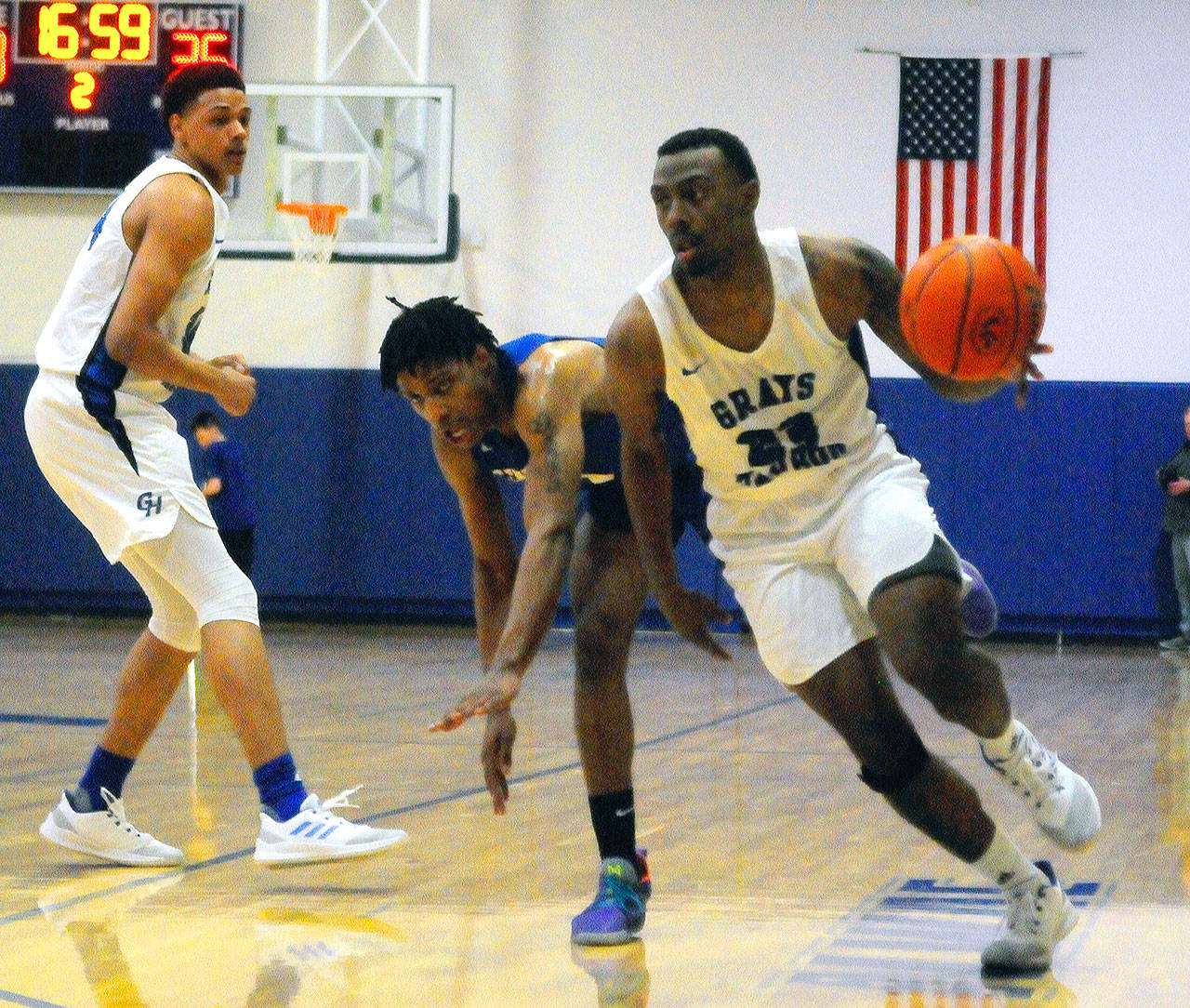 Jordan Gardner, right, drives to the hoop after getting a screen from Carl Fsicher, left, in the second half against Centralia. (Hasani Grayson | Grays Harbor News Group)