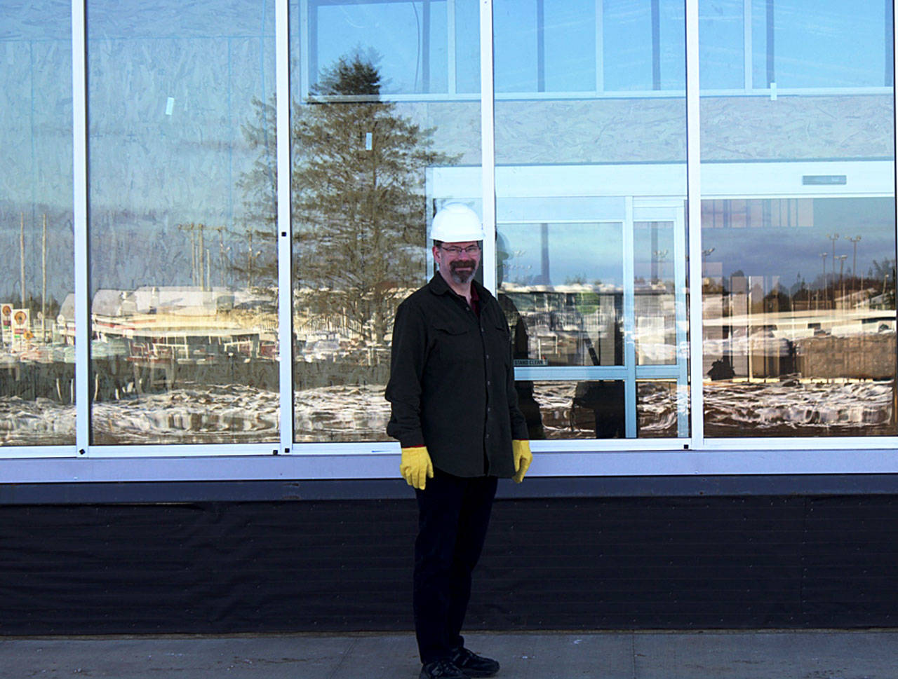 Angelo Bruscas photo: Stephen Buck stands in front of what will be the new entrance to the future home of Buck Electric/Ace Hardware, which will relocate this spring to the facility on Pt. Brown.