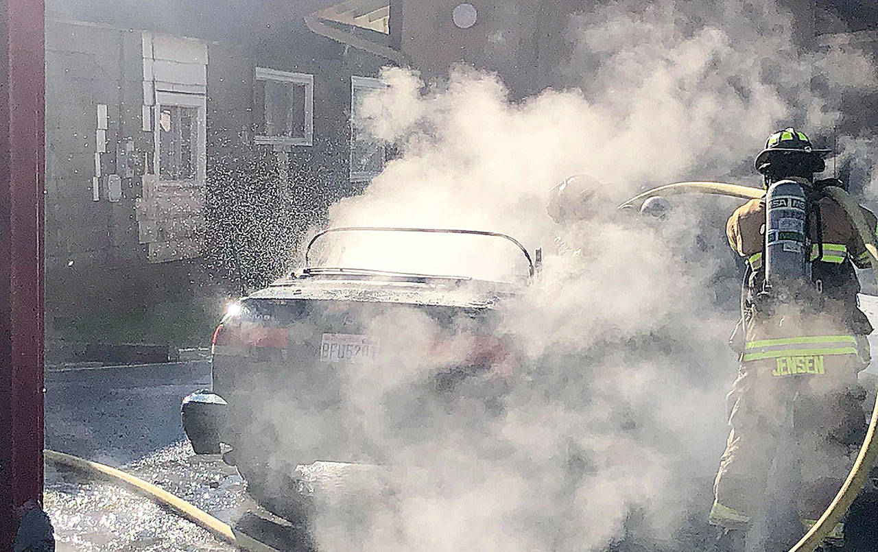 COURTESY HOQUIAM POLICE DEPARTMENT Hoquiam firefighters extinguished a fully involved car fire in an alley behind an apartment complex in the 2500 block of Sumner Avenue Friday morning.