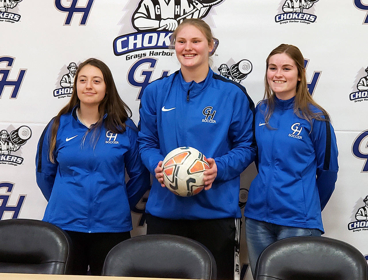 Ocosta High School’s Kristi Raffelson, center, and Mercedes Denny, right, stand along side former Ocosta player and current Grays Harbor midfielder Adrianna Huerta after a signing ceremony at Grays Harbor College on Thursday. (Ryan Sparks | Grays Harbor News Group)