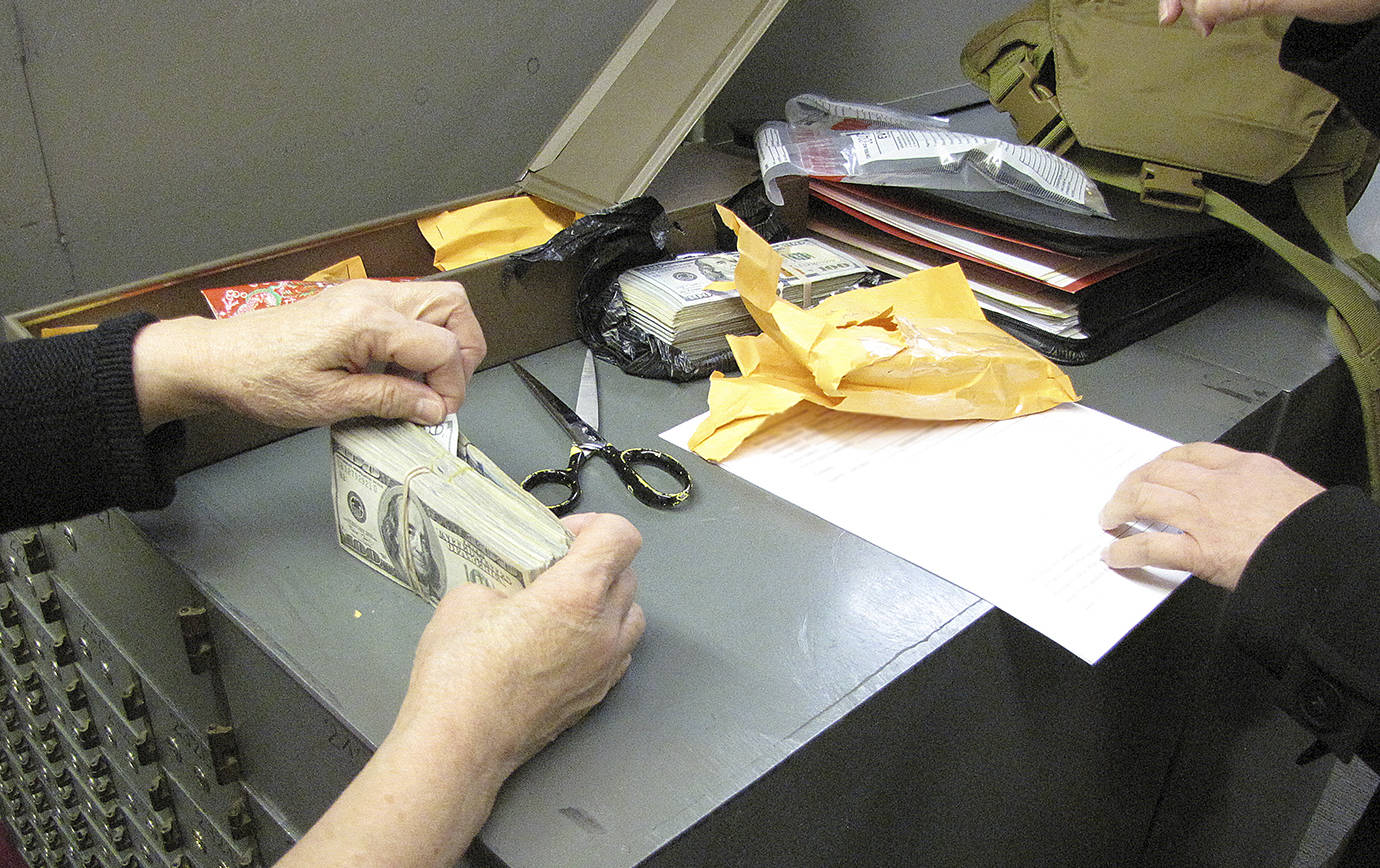 COURTESY GRAYS HARBOR DRUG TASK FORCE                                Thousands of dollars in cash were seized during the Green Jade busts of late 2017. Stacks of bills were found in safe deposit boxes, home safes, designer handbags and, in at least one case, hidden inside a ceiling light fixture.