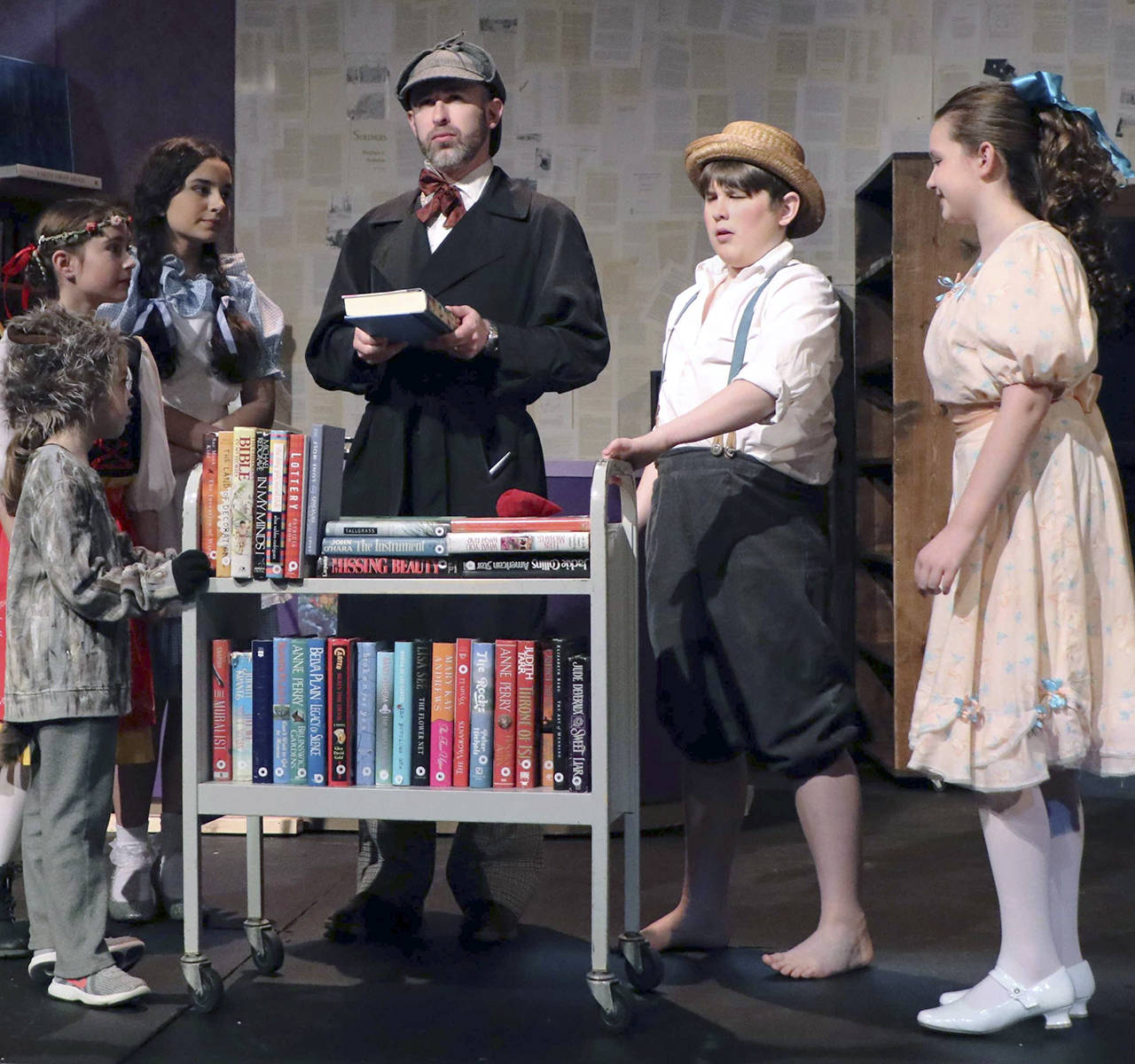 (Photo by Keith J. Krueger) Sherlock Holmes (played by Adam Turpin), center, speaks with other characters, from left: Toto (Aubriel Muñoz), Heidi (Emily Mefford), Dorothy (Alena Membreño), Tom Sawyer (Michael Turpin) and Pollyanna (Madi Valentine).