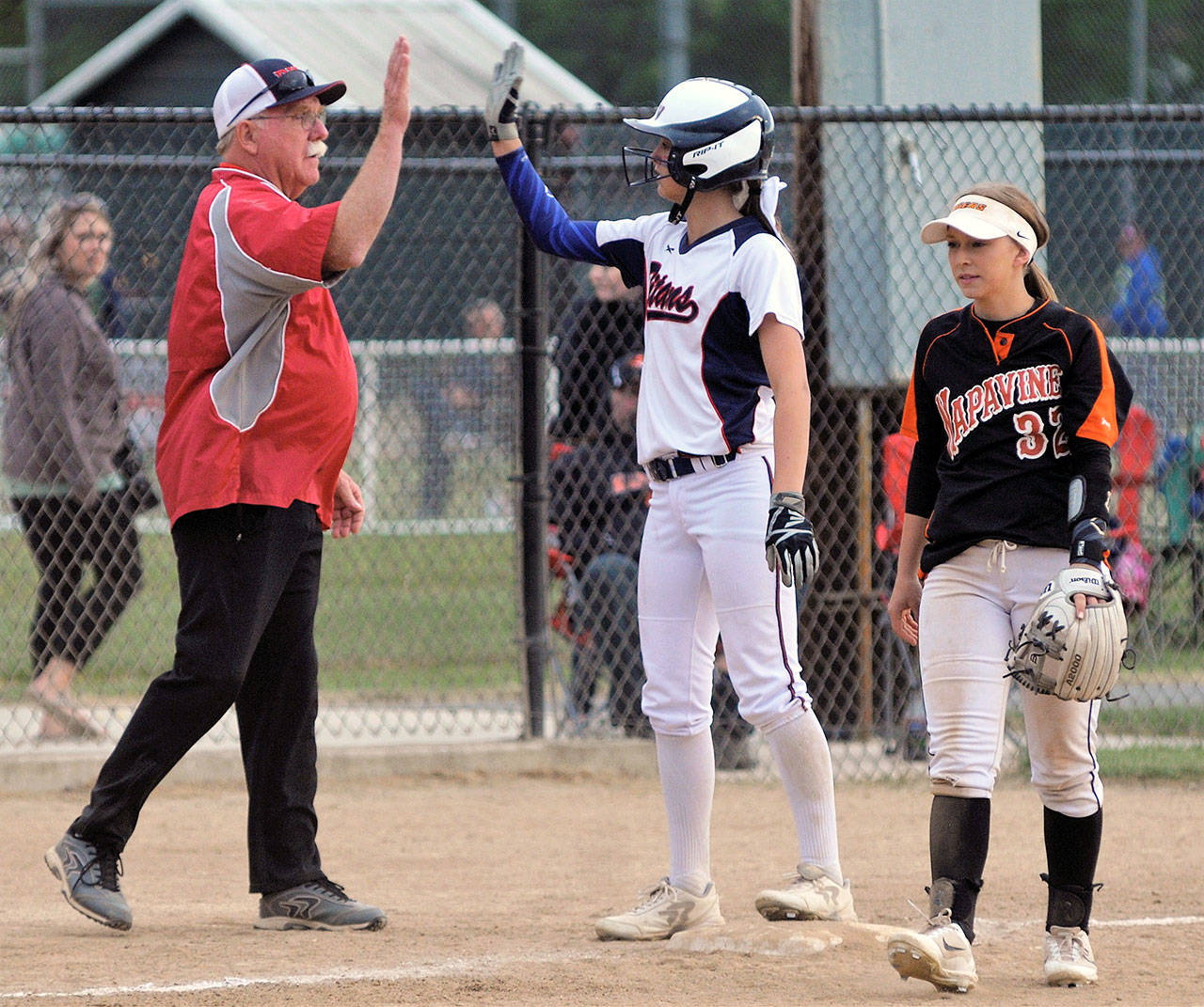PWV head coach Ken Olson, left, high-fives Britney Patrick during the 2B District IV Championship game in May, 2018. (Daily World File Photo)