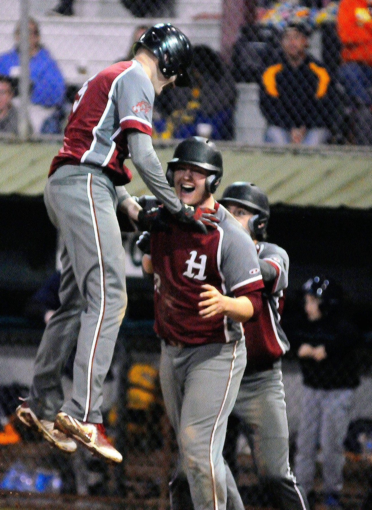 Hoquiam’s Kyle Larsen, left, celebrates with Liam Odell after Larsen scored the game-winning run against Aberdeen on Wednesday. (Hasani Grayson | Grays Harbor News Group)