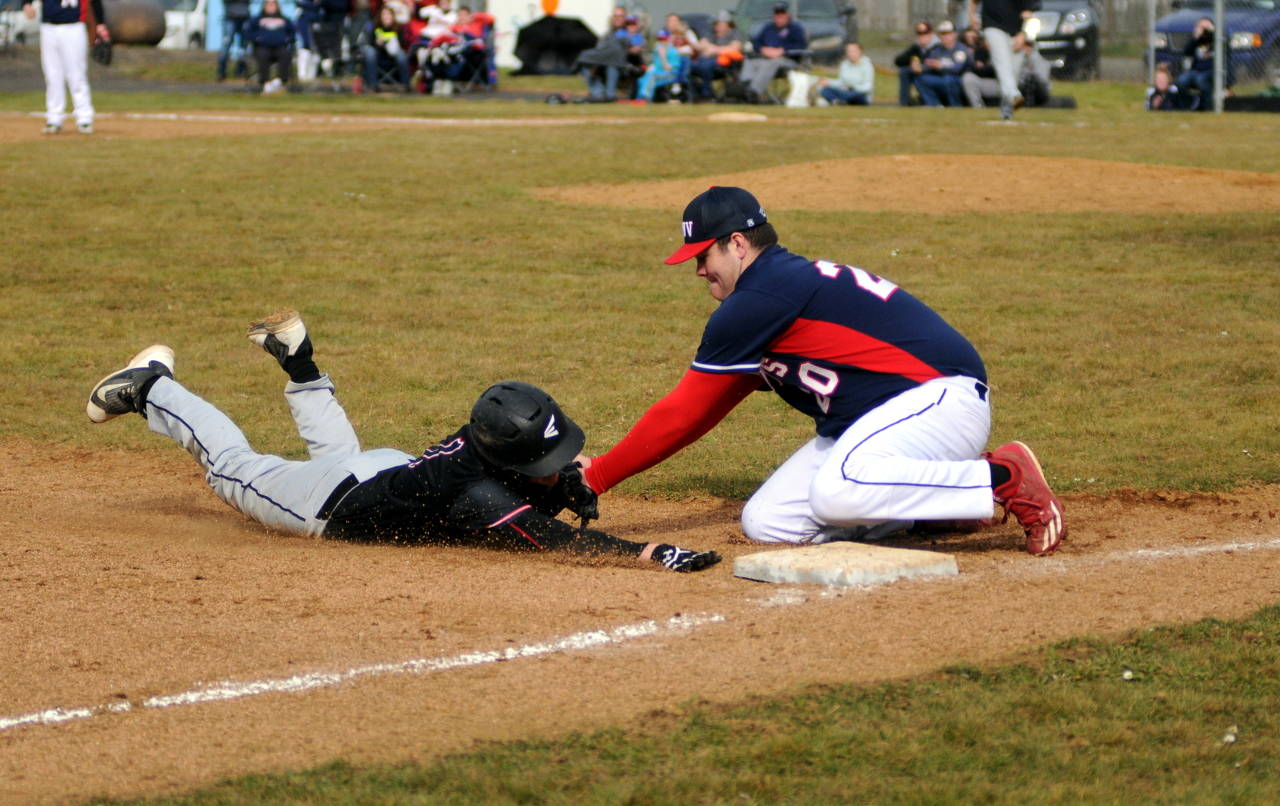 PWV third baseman Kobe Hoffman, right, tags out Raymond’s Mason Crawford on a close play in the second game of a doubleheader on Saturday in Raymond. (Ryan Sparks | Grays Harbor News Group)