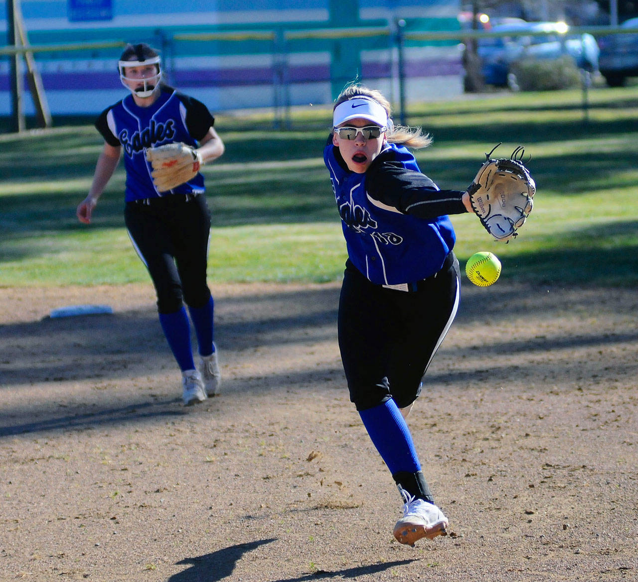 Elma’s Destry Dineen flips the ball out of her glove to first basemen Jalyn Whipple to record the third out of the second inning on Monday against Ocosta. (Hasani Grayson | Grays Harbor News Group)