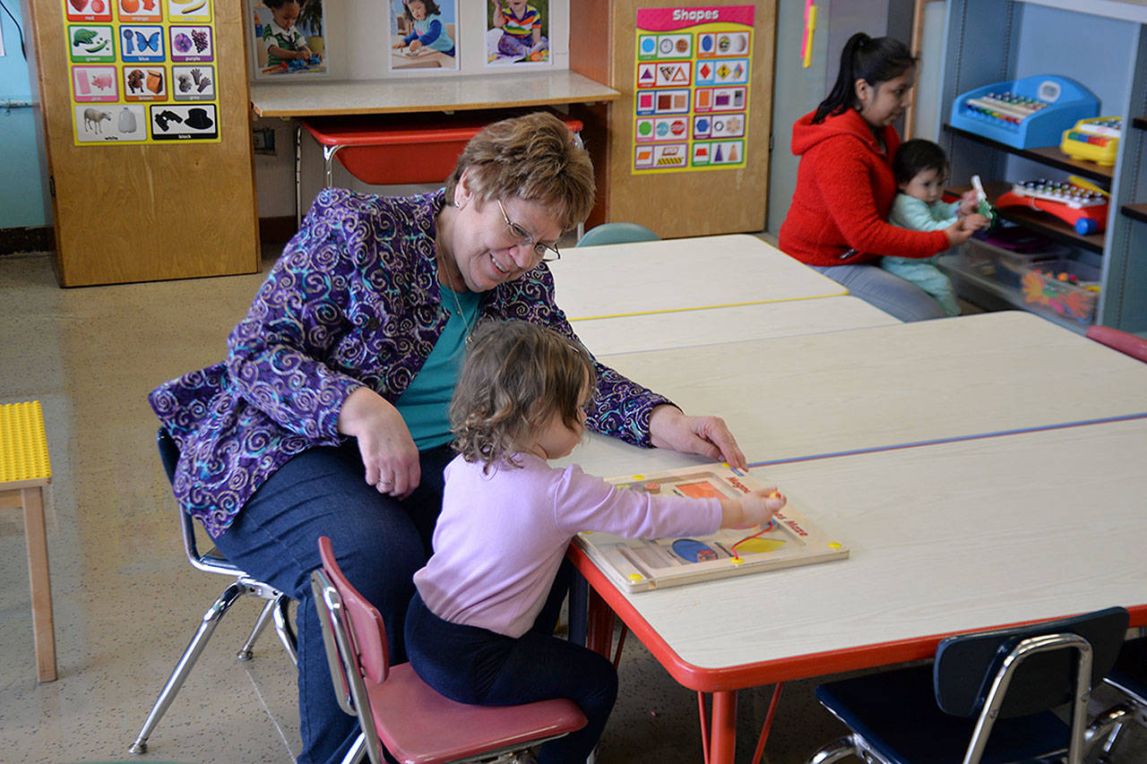 (Louis Krauss | Grays Harbor News Group)                                Gayle Capsel, director of Snug Harbor, plays with a child at the daycare Friday.
