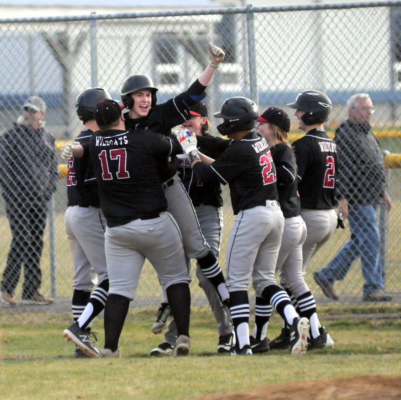 Ocosta’s Colby Scheuber (arm raised) celebrates with teammates after driving in the game-winning run with a single in the bottom of the eighth inning in game two of a doubleheader on Saturday in Pe Ell. (Ryan Sparks | Grays Harbor News Group)